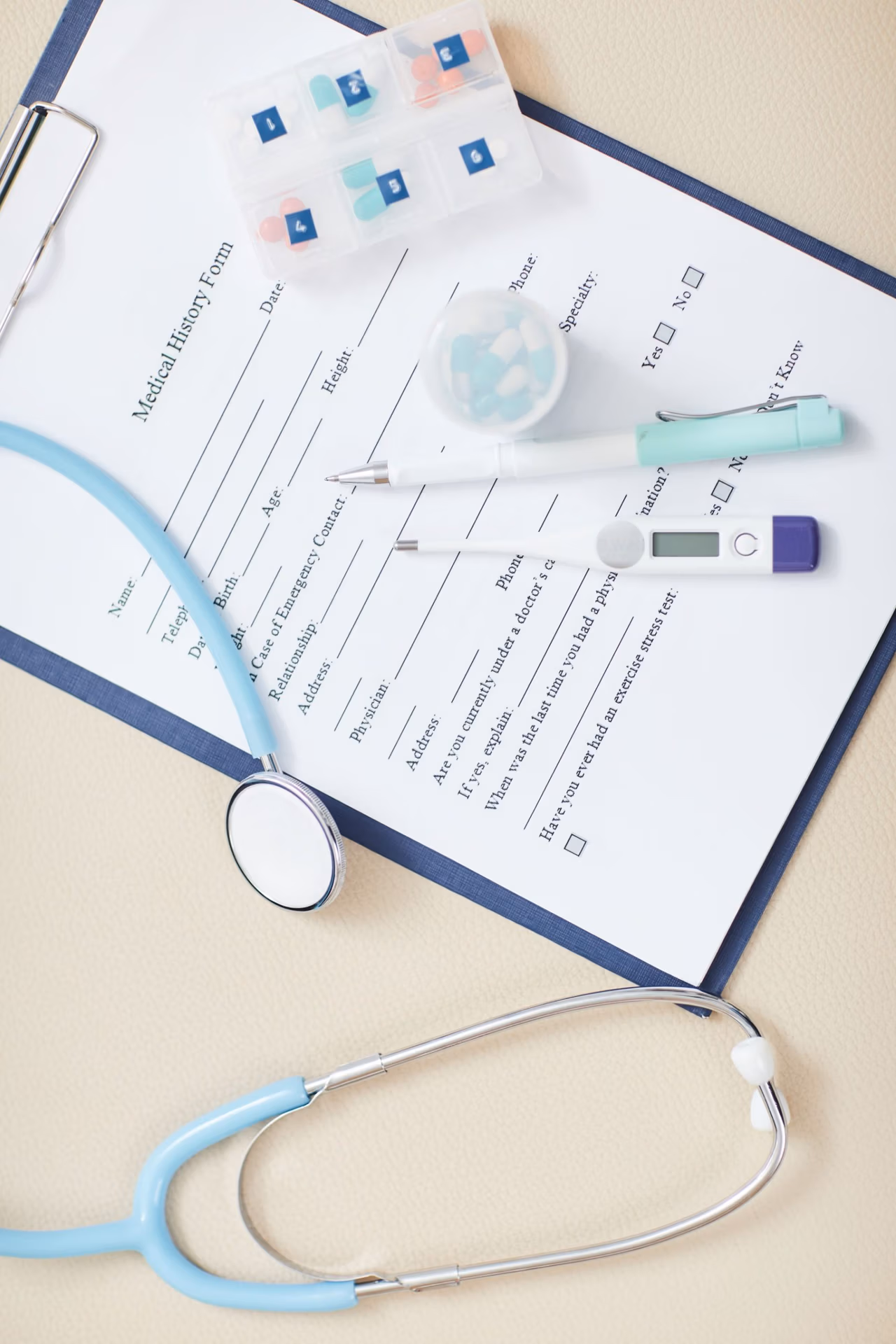 Top view background of medical form on clipboard with stethoscope over it