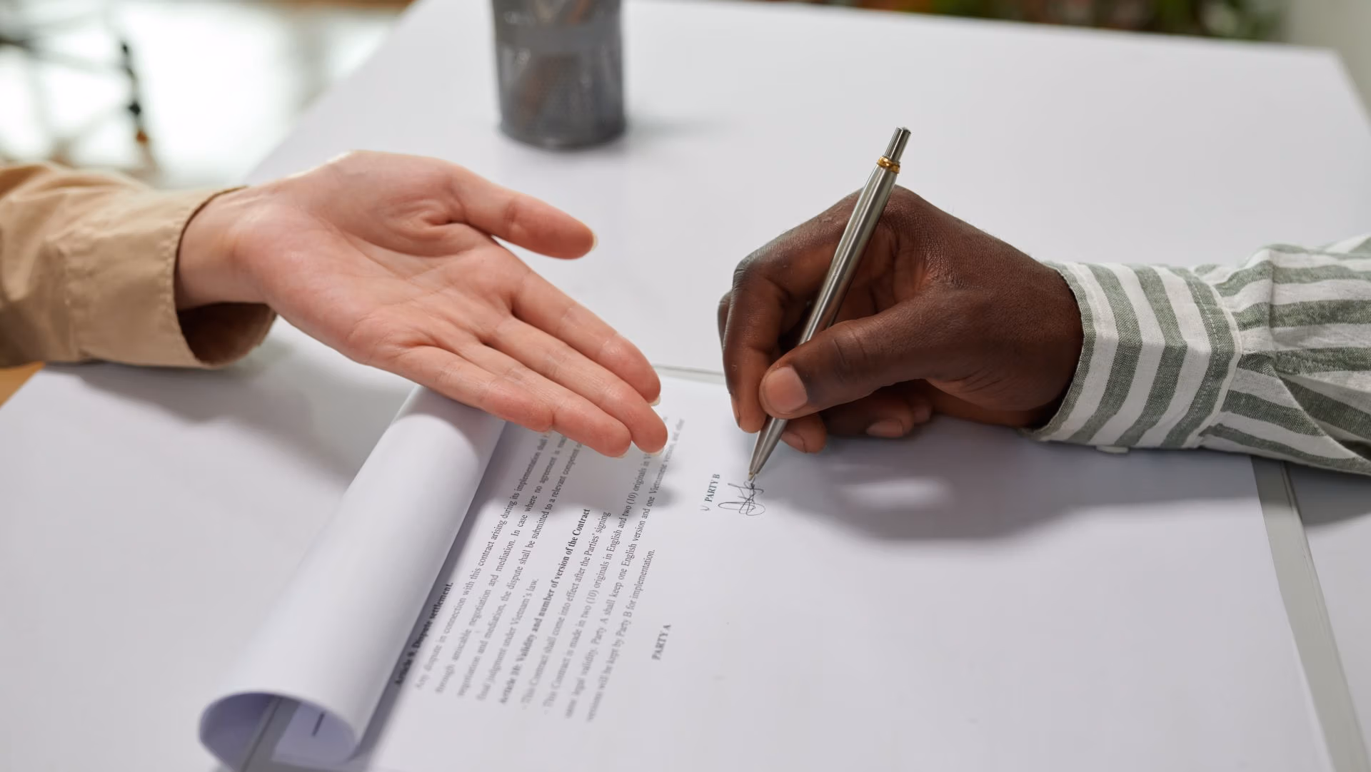 Close-up of a person signing legal documents, symbolizing guardianship, conservatorship, and important legal agreements.