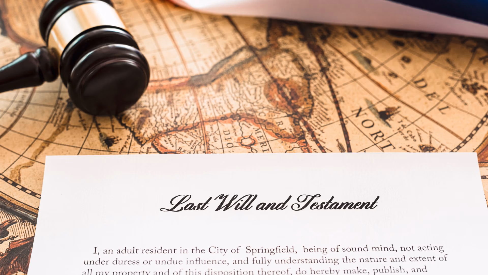 Last Will and Testament document with gavel on vintage map background
