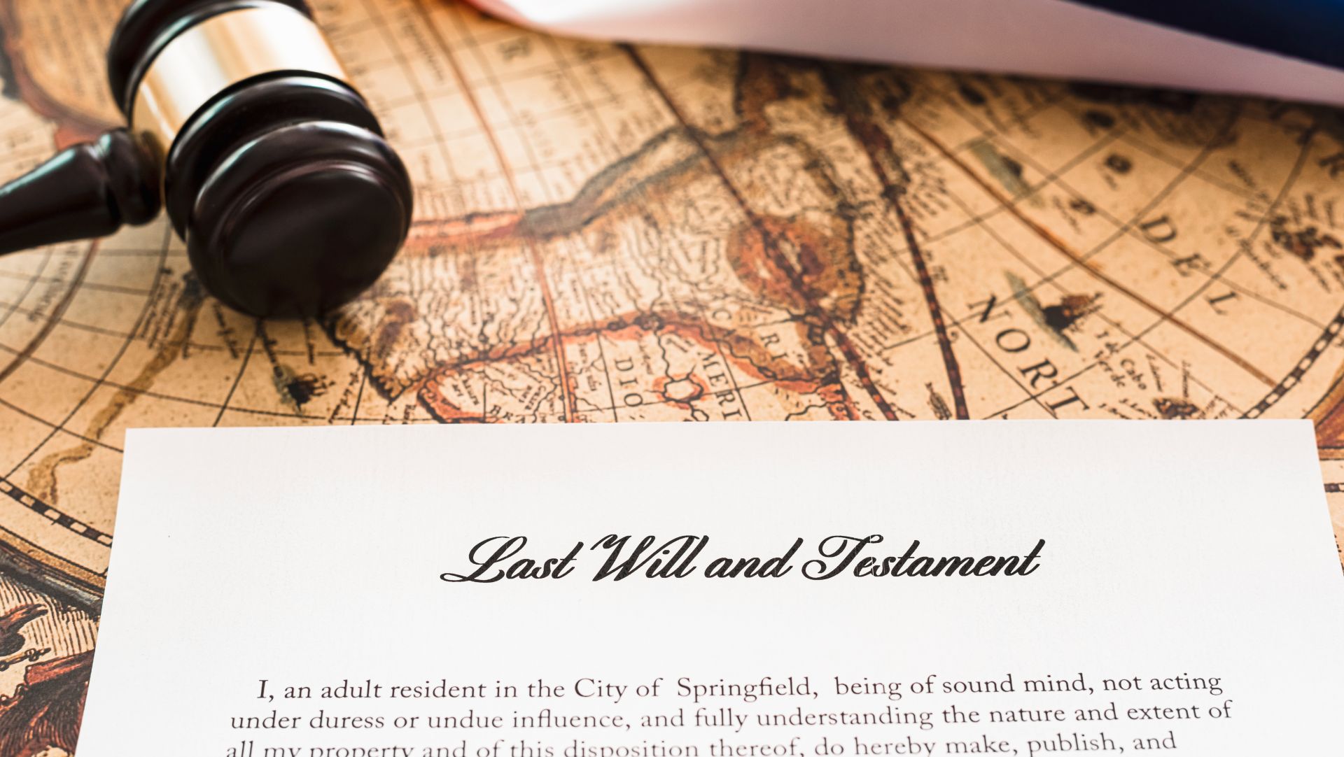 Last Will and Testament document with gavel on vintage map background