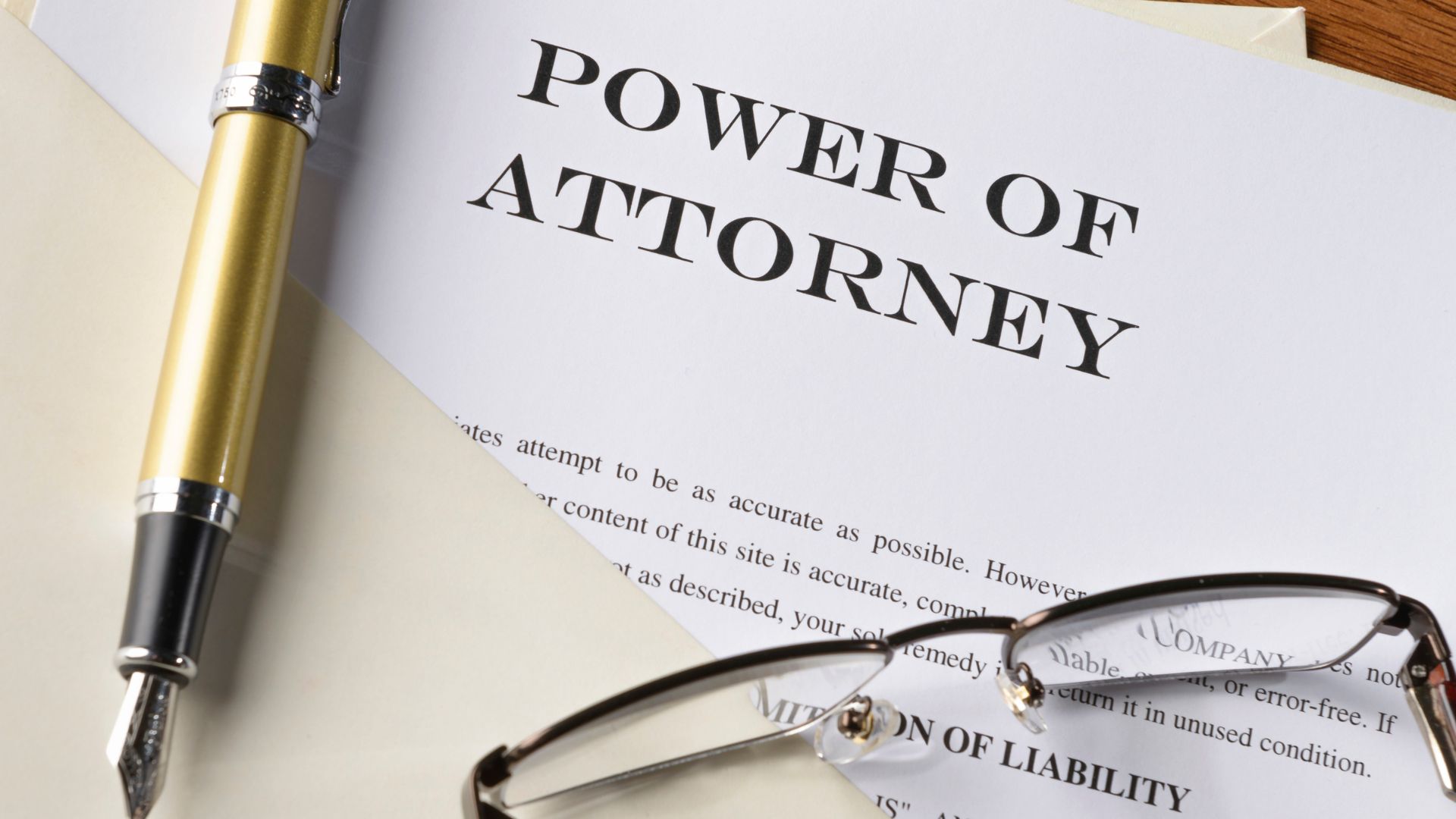Power of Attorney document with pen and glasses on desk