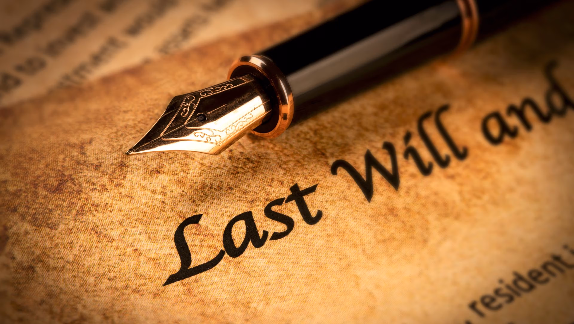 Fountain pen resting on Last Will and Testament document