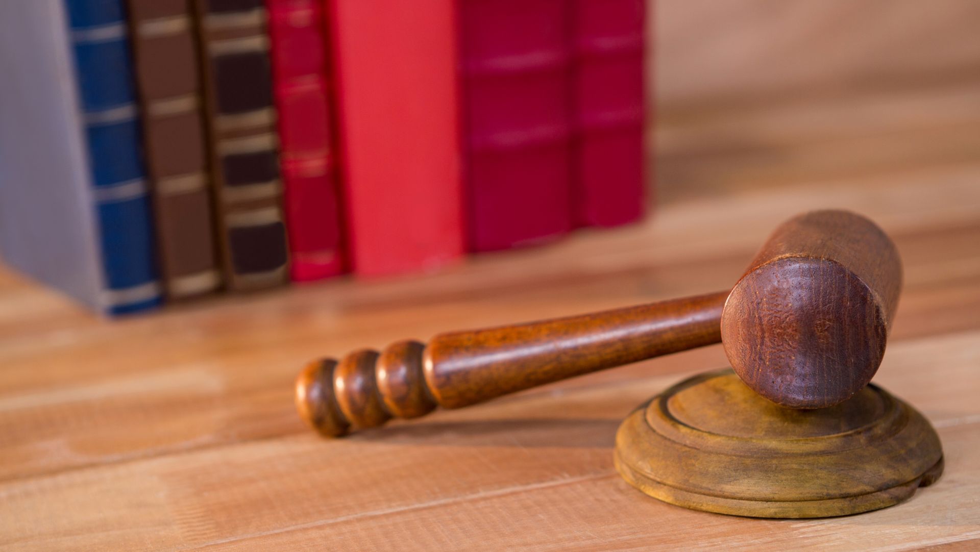 Judge’s gavel resting on a wooden block with law books in the background, symbolizing probate and legal process.