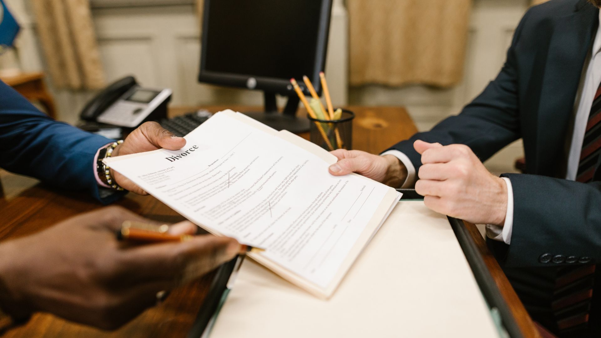 Lawyer handing over divorce documents for review and signature during a legal consultation.