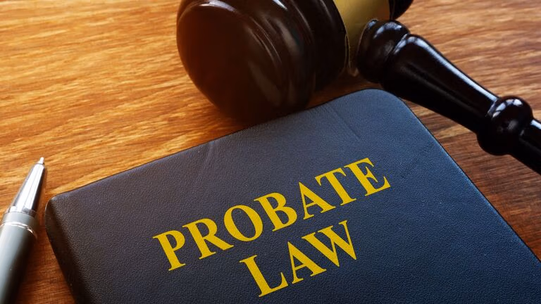 Gavel and book titled Probate Law on wooden desk, symbolizing Virginia probate costs and taxes.