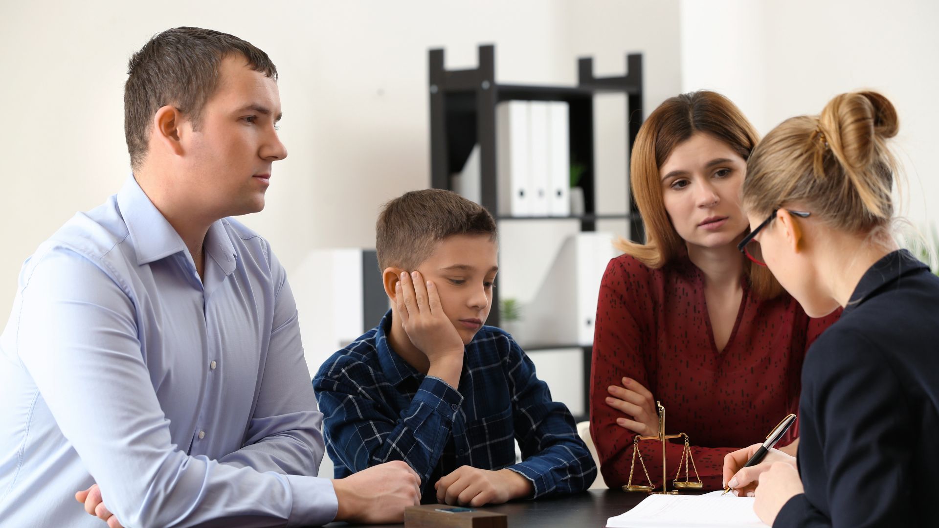 Adult child and elderly parent meeting with elder law attorney to discuss Medicaid planning
