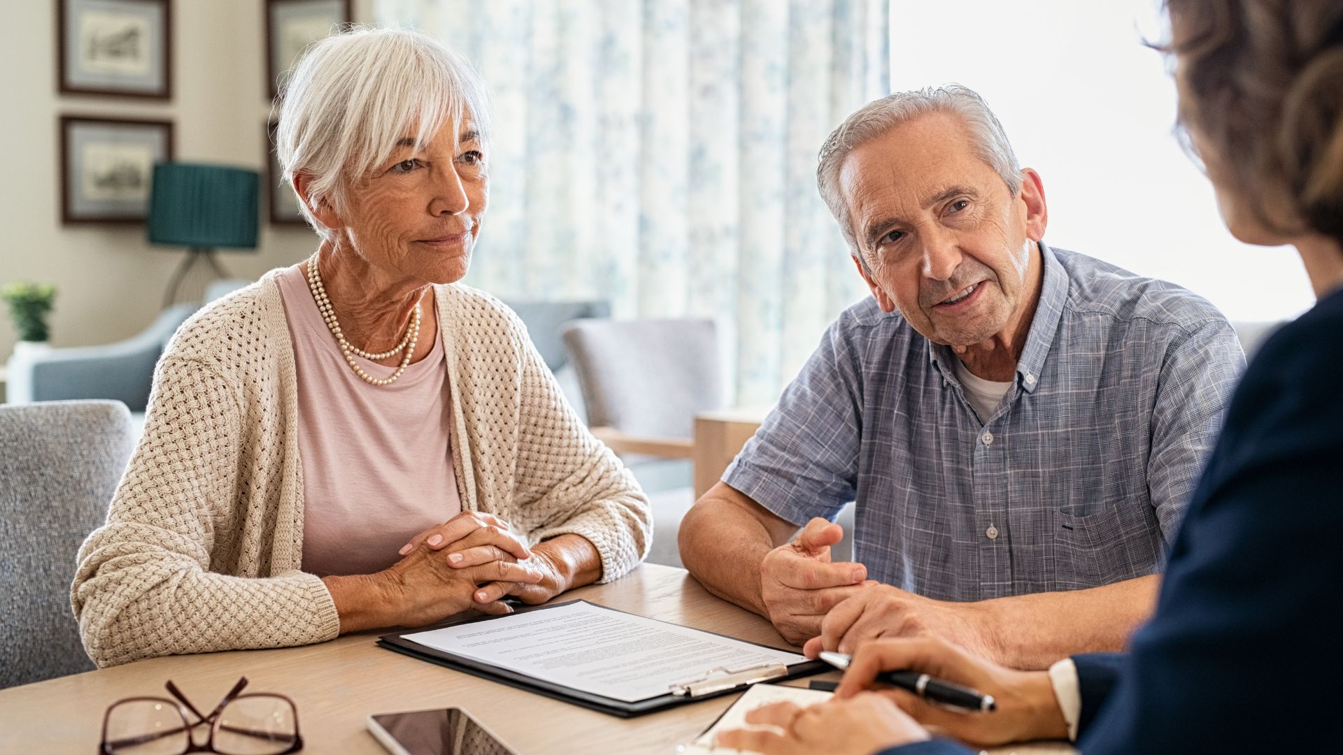 Elderly couple reviewing estate planning documents with attorney