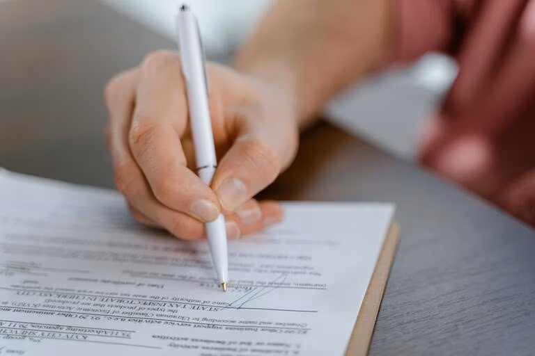 Person signing a legal document such as a living trust or will