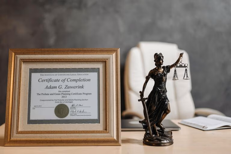 Lady Justice figurine and a probate certificate on a desk, representing Virginia probate timeline