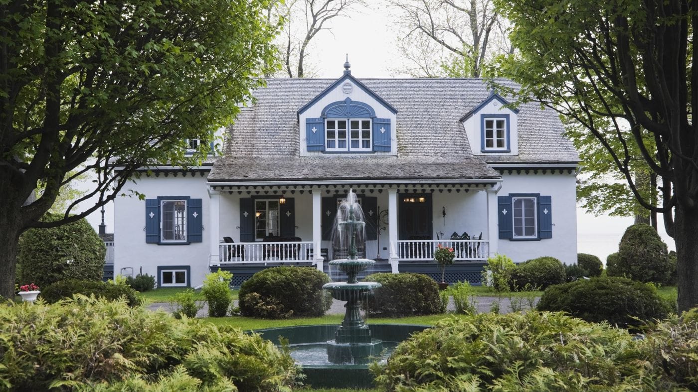 A white house surrounded by a garden