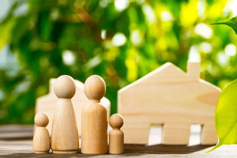 Wooden family and house figures protected by a Medicaid Asset Protection Trust in Virginia